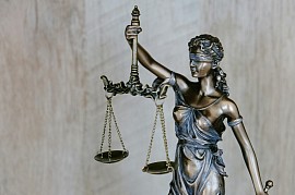 Lady justice holding the evenly balanced scales of the justice system